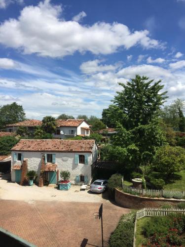 a house with a car parked in a driveway at La Pergola B&B in Cesena
