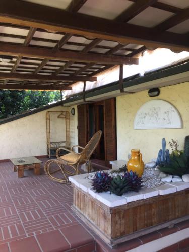 a patio of a house with a table and a chair at La Pergola B&B in Cesena