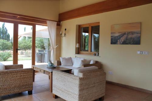 a living room with two chairs and a table at Finca Verde in Llucmajor