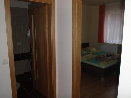 a small bedroom with a bed and a window at Park - apartmány na prenájom in Nové Mesto nad Váhom