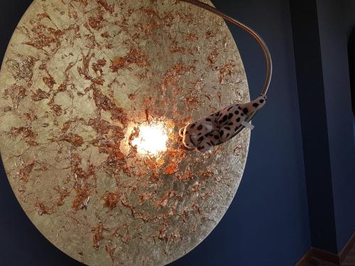 una luz colgando del techo con una mariposa. en Hotel Vergeiner, en Seefeld in Tirol