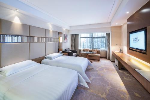 Kama o mga kama sa kuwarto sa Galaxy minyoun Chengdu Hotel