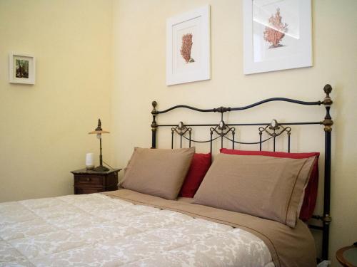 a bedroom with a large bed with red pillows at Turenum Apartment B&B in Trani