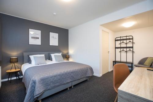 a hotel room with a bed and a chair at OnlySleep Trafikcenter in Slagelse