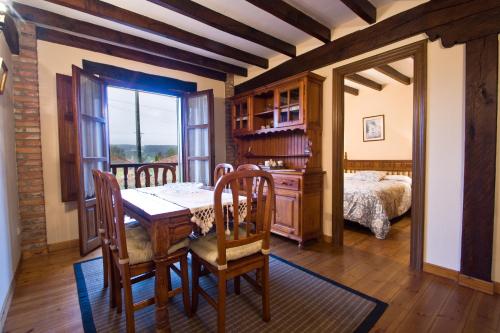 a dining room with a table and a bedroom at Vivienda Casa Luisa in Comillas