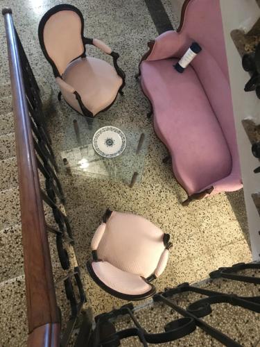 two chairs and a couch sitting on the floor at Via Mazzini in Bazzano
