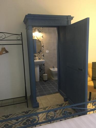 a bathroom with a mirror and a bathroom with a sink at Via Mazzini in Bazzano
