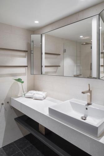 a bathroom with a sink and a mirror at At Six in Stockholm