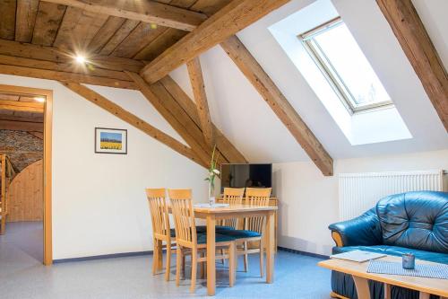 a living room with a table and a couch at Pension Schizentrum Grosseck - Speiereck in Mauterndorf