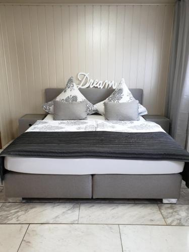 a bedroom with a bed with a black and white comforter at Scholz & Scholz GbR Zimmervermietung in Hoyerswerda