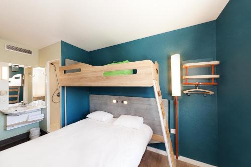 um pequeno quarto com um beliche e uma casa de banho em ibis budget Saint Gaudens em Estancarbon