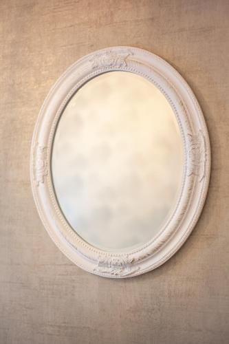 a white plate hanging on a wall at Lebu Apartment TBS in Tbilisi City