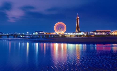 a view of a city at night with the eiffel tower at Willow Lodge Hambleton in Poulton le Fylde
