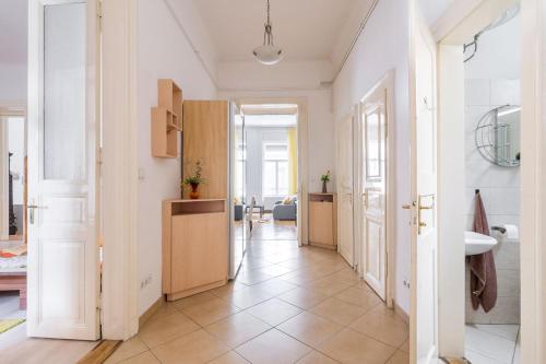 a hallway with a bathroom and a sink in a room at Izabella Home 2 Budapest in Budapest