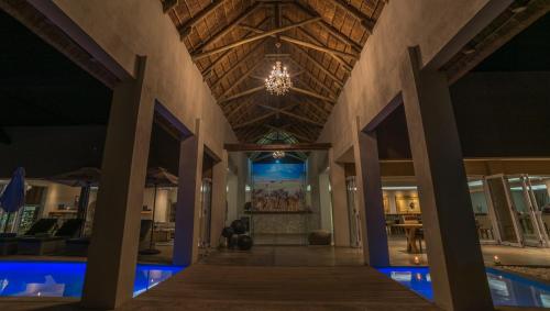 a hallway of a house with a ceiling with a chandelier at Toshari Lodge in Okaukuejo