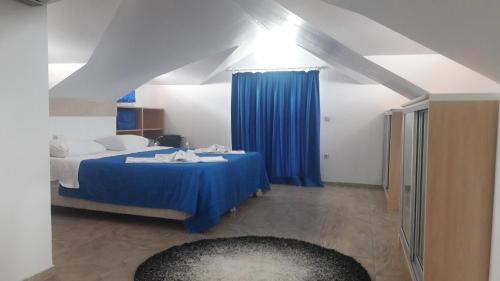 a bedroom with a blue bed with a blue curtain at Rota Hotel in Dalyan