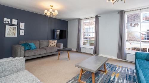 a living room with a couch and a table at Malt Shovel Court with Free Parking in York