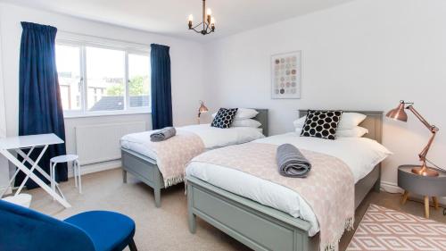 a bedroom with two beds and a window at Malt Shovel Court with Free Parking in York