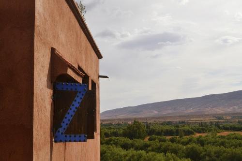 a building with a blue x on the side of it at Villa Paradise in Aghmat