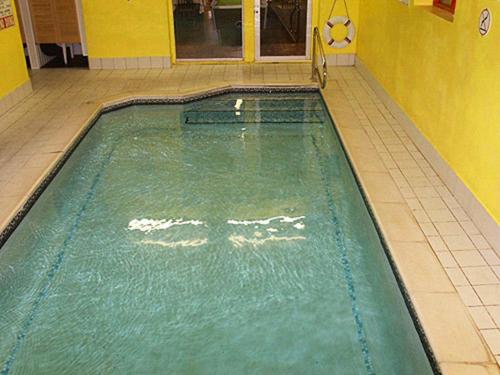 a swimming pool in a room with a tiled floor at The Woodfield Hotel in Blackpool