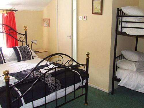 a bedroom with two bunk beds and a ladder at The Woodfield Hotel , Indoor Heated swimming pool, Spacious lounge and Bar in Blackpool