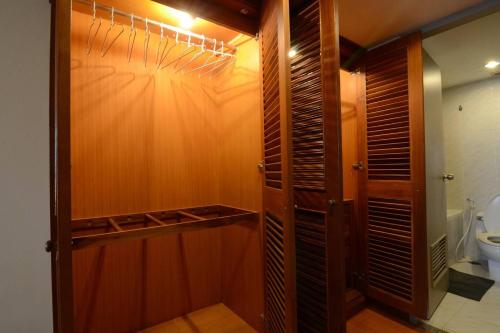 曼谷的住宿－Omni Towers - Large 1 Bedroom Condo Soi Nana，一间带卫生间的浴室和一个木制衣柜