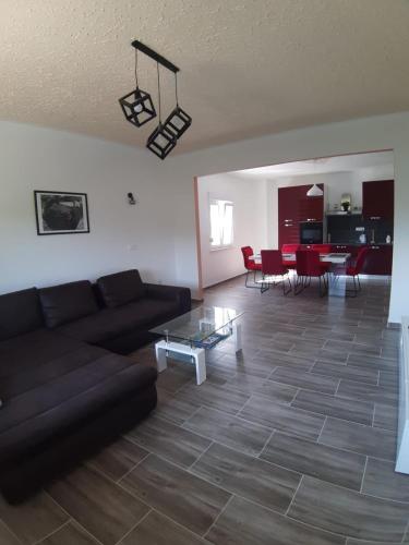 a living room with a couch and a table at Holiday House Ivan in Donji Zemunik