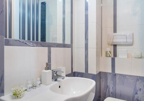 a bathroom with a sink and a mirror at Fiorentini Residence NAPOLI in Naples