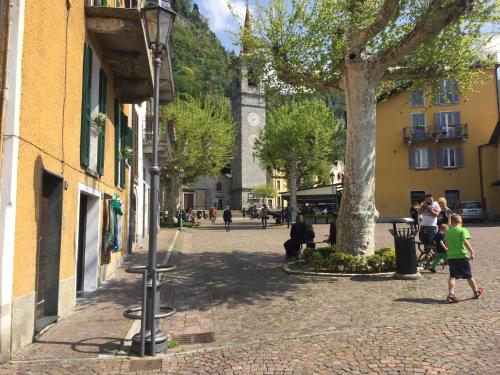 a street in a town with a clock tower at Petit Bijou in Varenna