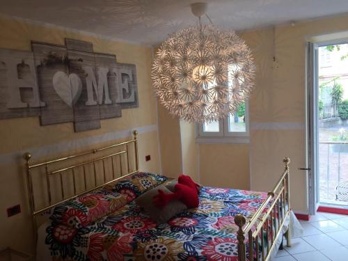 a bedroom with a bed and a chandelier at Petit Bijou in Varenna