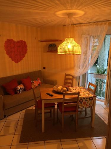 a living room with a table and a couch at Petit Bijou in Varenna