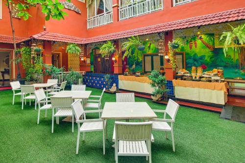 a restaurant with tables and chairs in front of a building at Mayfair Rourkela in Panposh