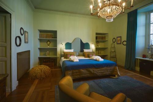 a bedroom with a bed and a chair and a chandelier at Look To in Turin