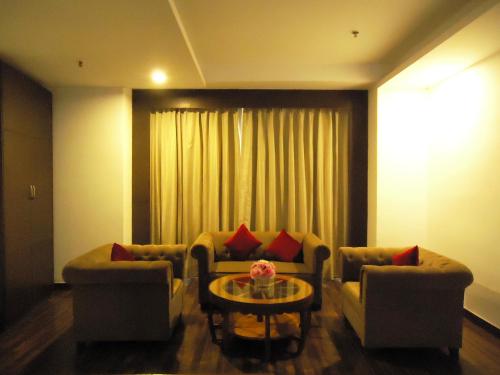 a living room with two couches and a table at Velvet Clarks Exotica in Chandīgarh