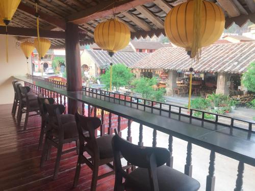a bar with chairs and lights on a balcony at Ancient Town 29 Phố Cổ in Dồng Văn