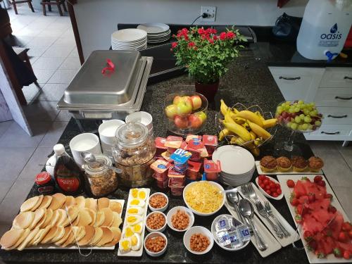 a table with many different types of food on it at Dilisca Guesthouse in Durbanville