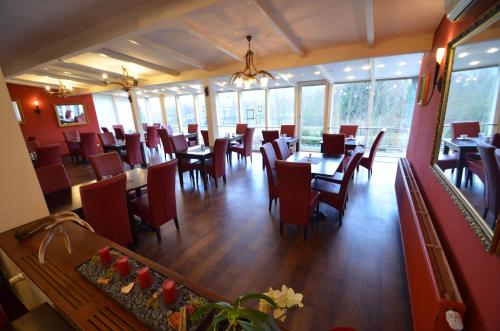 a dining room with tables and chairs in a restaurant at Landhotel Christopherhof in Grafenwiesen