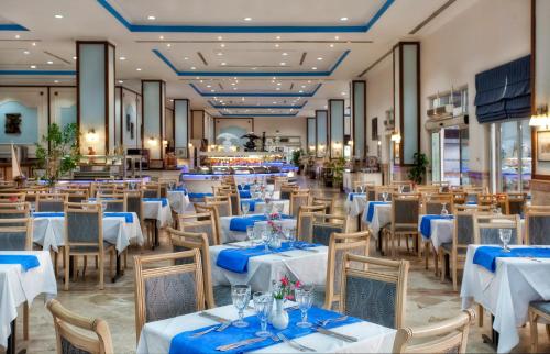 een eetkamer met witte tafels en stoelen bij Selectum Colours Bodrum in Gümbet