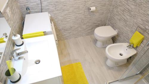 a bathroom with a white toilet and a sink at Apartment Mistral in Badesi