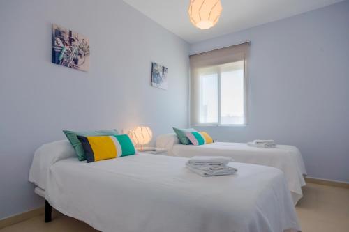 Ένα ή περισσότερα κρεβάτια σε δωμάτιο στο Apartamento Sea Views Rota