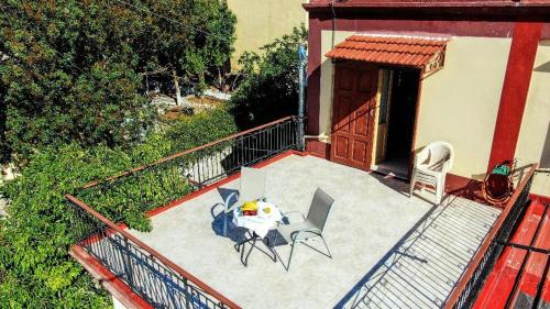 a balcony with a table and chairs on a patio at Agnanti house in Symi
