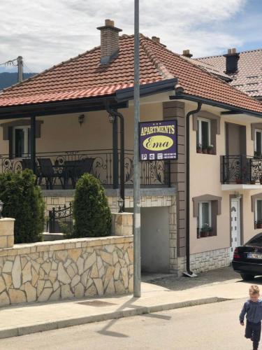 a little boy walking in front of a building at Ema Guest House in Plav