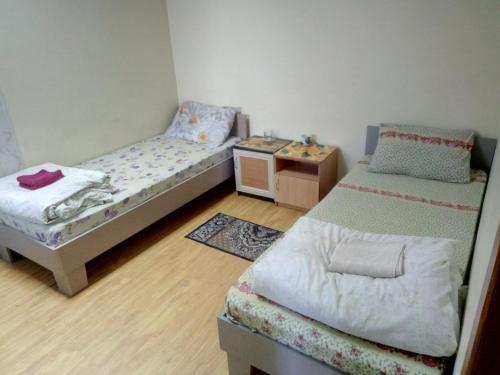 a small bedroom with a bed and a desk at Hotel Uyut in Bilhorod-Dnistrovskyi