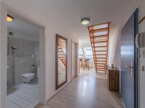 a bathroom with a toilet and a staircase in a house at Ferienwohnung Seeblick in Waren
