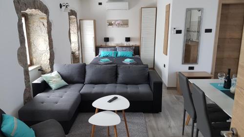 ein Wohnzimmer mit einem Sofa und einem Bett in der Unterkunft Villa Kos in Lupoglav