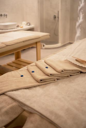 a pair of towels sitting on top of a table at Acroterra Rosa Luxury Suites & Spa in Akrotiri