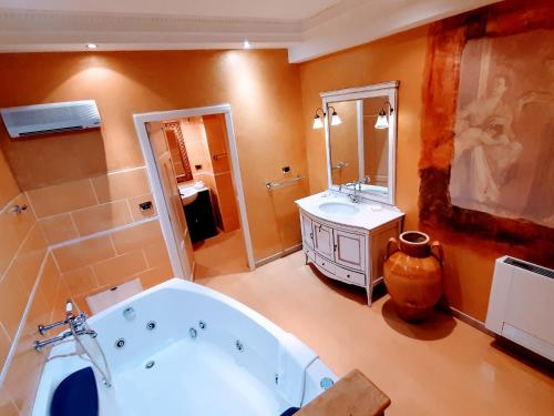 a large bathroom with a tub and a sink at Hotel Villa Antica Tropea in Tropea