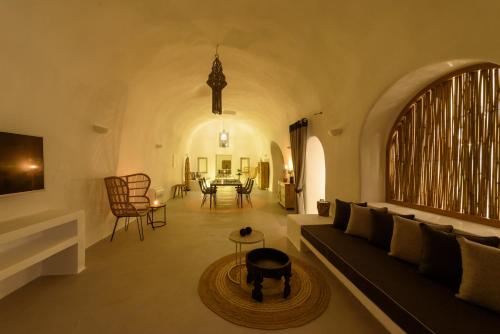 a living room with a couch and a table at Adele Villa by Senses Collection in Pirgos