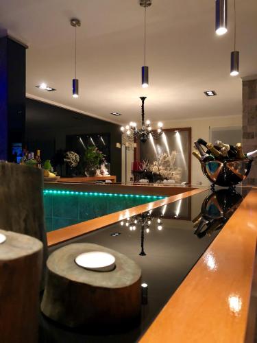 a kitchen with a bar with a wooden counter top at Quinta Da Bela Vista in Ponta Delgada