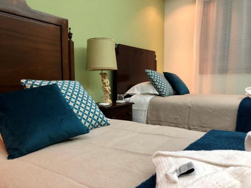 a bedroom with two beds and a lamp on a table at Quinta Da Bela Vista in Ponta Delgada